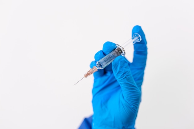 Doctor holding coronavirus vaccine in his hand