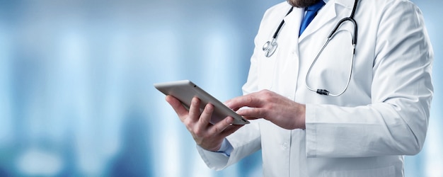 Doctor holding digital tablet, close-up view