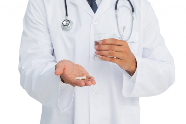 Doctor holding drugs and glass of water