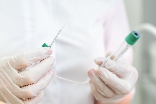 Doctor holding empty plasmolifting device with a needle