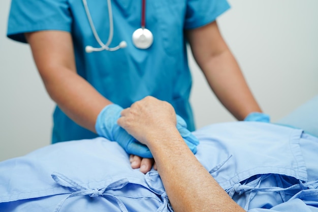 Doctor holding hands Asian elderly woman patient help and care in hospital