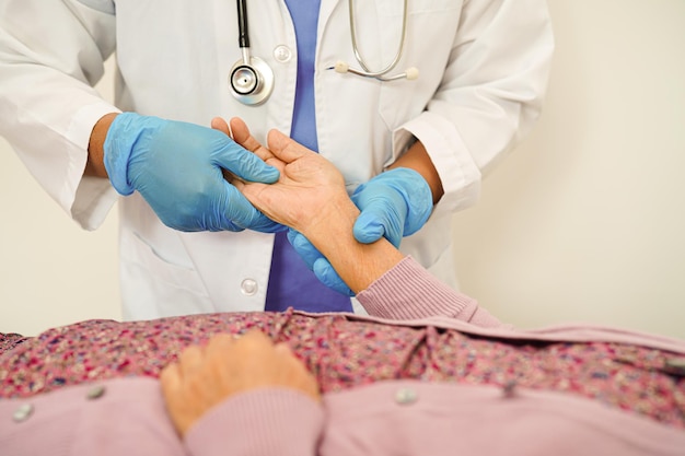 Doctor holding hands Asian elderly woman patient help and care in hospital