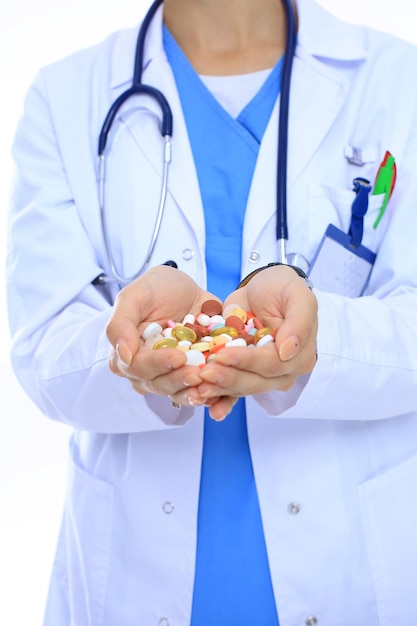 Doctor holding heap of drugs in a hand Woman doctor