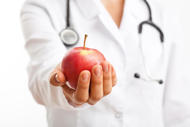 A doctor holding a red apple in his hand