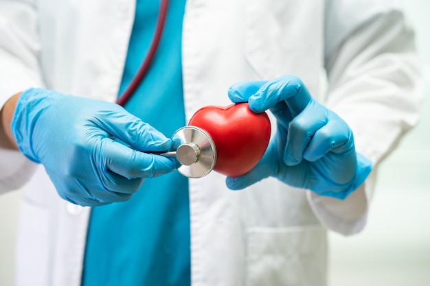 Doctor holding a red heart in hospital ward healthy strong medical concept