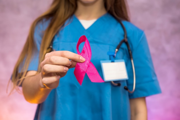 Doctor holding red ribbon. AIDS world day. Social advertising