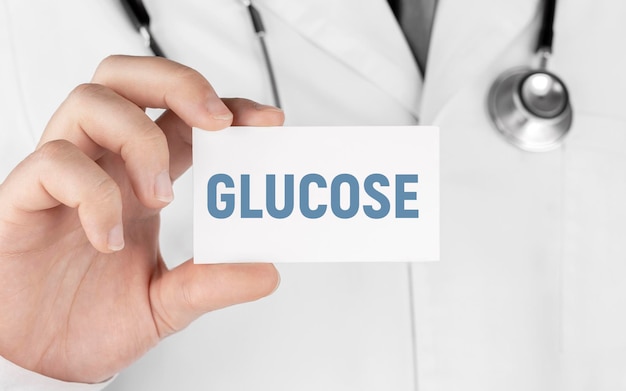 Doctor holding a sticker with text Glucose Medical concept