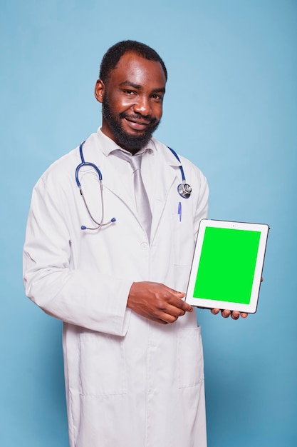 Doctor holding tablet with green screen