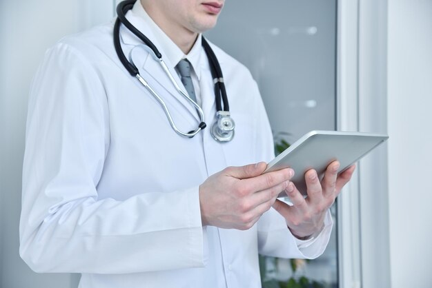 Doctor holding a touch pad tablet computer