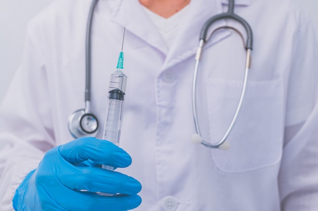 A doctor holding a vaccine