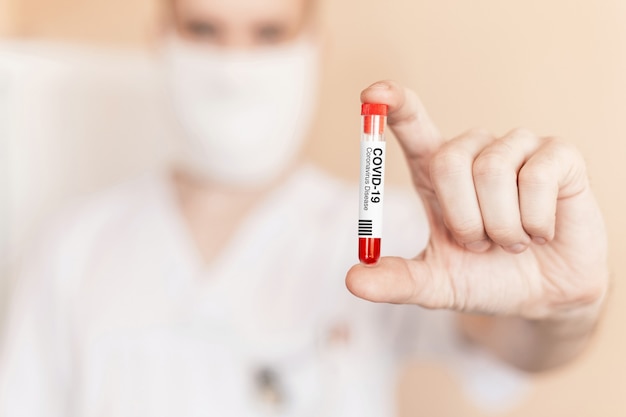 Doctor holds in hand a test tube with coronavirus. COVID-19 Infectious Disease Vaccine. Antidote