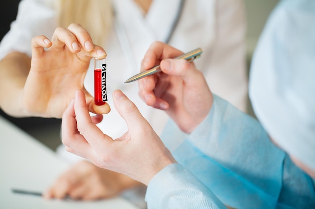 Doctor holds test tube with covid-19 test.