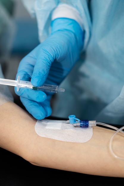 Doctor injecting the anesthesia on patient's arm