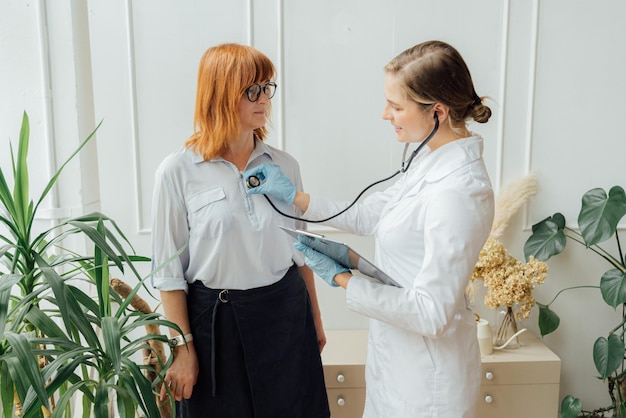 A doctor is checking a patient's blood pressure.