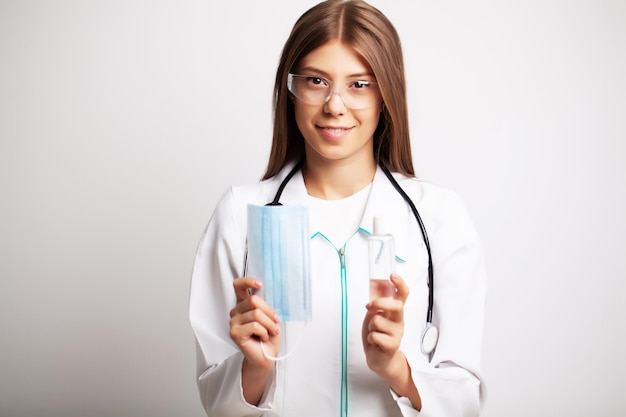 Doctor is holding personal protective equipment against a viral infection.