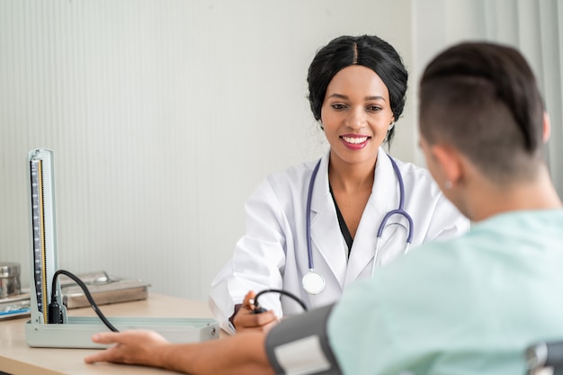 doctor is measuring blood pressure for the patient