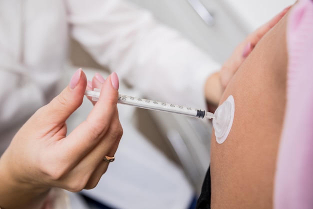 Doctor makes an injection of insulin with a catheter