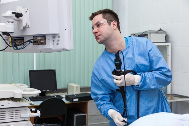 Doctor man in the monitor looks at the results of the colonoscopy