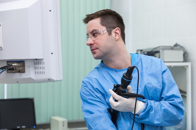 Doctor man in the monitor looks at the results of the colonoscopy