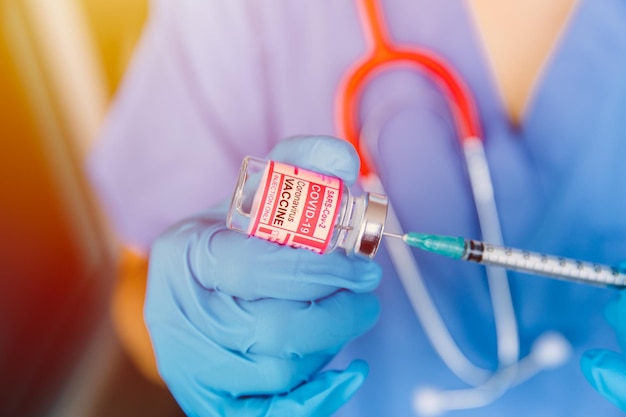 Doctor or Medical Technician holding Covid Vaccine dose thaw separate injection with Sterile Technique