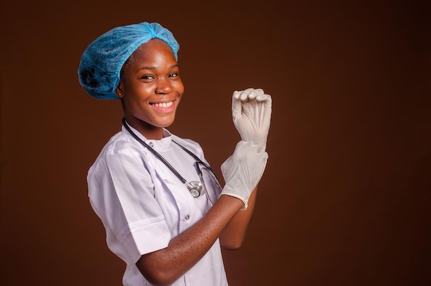 Doctor or Nurse Adjusting Surgical Gloves Wearing Personal Protective Equipment