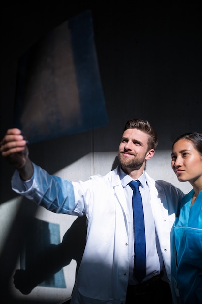 Doctor and nurse examining X-ray report