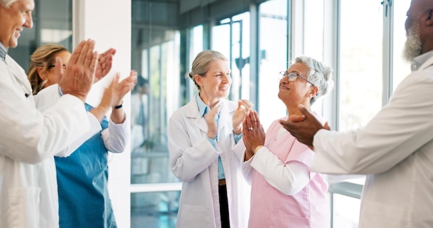 Photo doctor nurse and team applause in celebration for healthcare achievement goal or promotion at hospital group of medical professional clapping and celebrating teamwork unity or victory at clinic