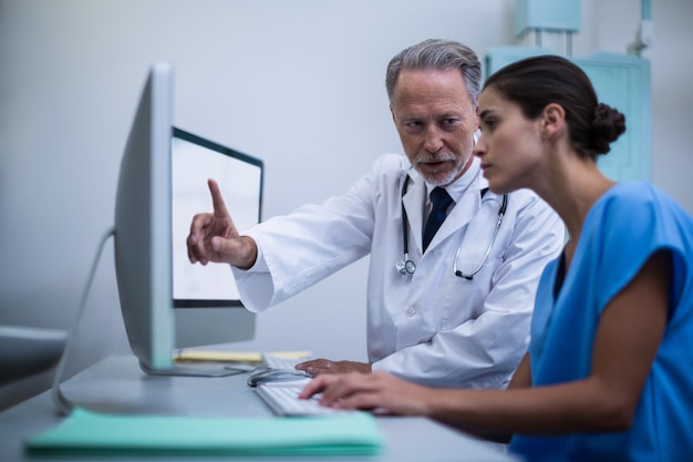 Doctor and nurse working on computer