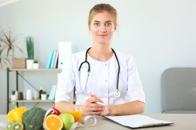 Doctor nutritionist in her office demonstrates the concept of healthy eating