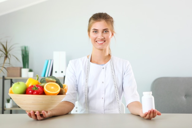 Doctor nutritionist in her office demonstrates the concept of healthy eating