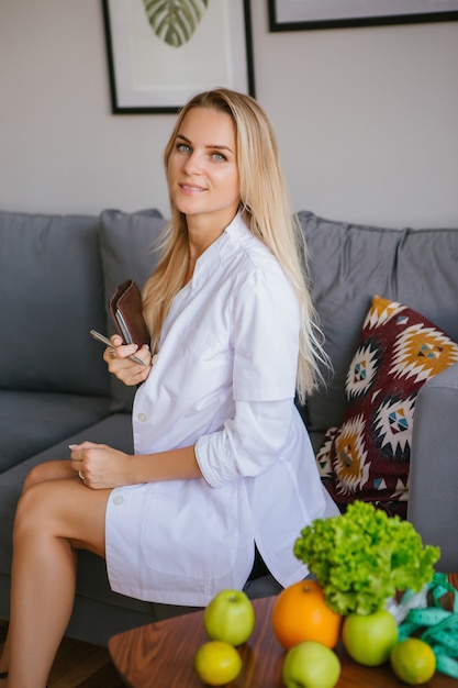 Doctor nutritionist sits in the office leading the reception