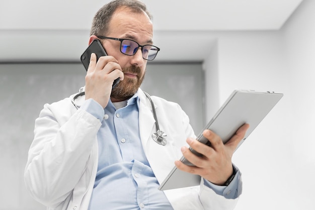 Doctor in office talking on phone