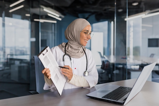 Doctor online consultation with patient muslim woman in hijab working remotely with laptop for video