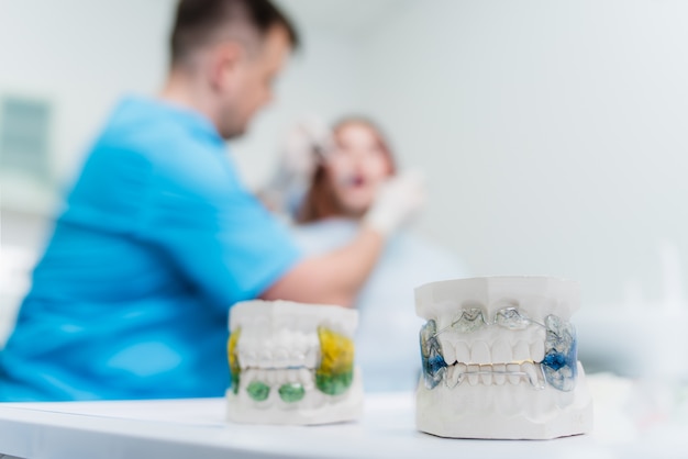 Doctor orthodontist examines the oral cavity of the patient