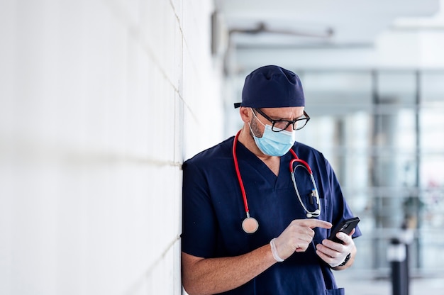 Doctor outside hospital using smart phone