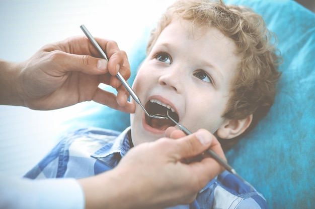 Doctor and patient child Boy having his teeth examined with dentist Medicine health care and stomatology concept