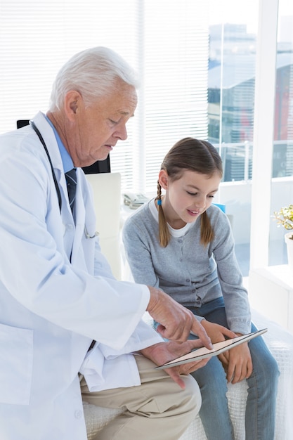 Doctor and patient discussing over digital tablet