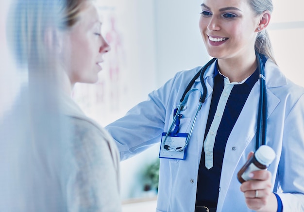 Photo doctor and patient discussing something while sitting at the table medicine and health care concept