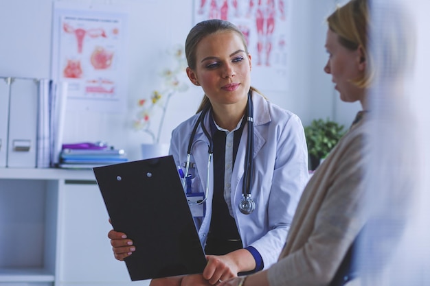 Doctor and patient discussing something while sitting at the table  medicine and health care concept