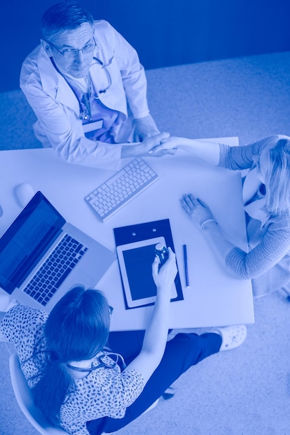 Doctor and patient discussing something while sitting at the table  medicine and health care concept