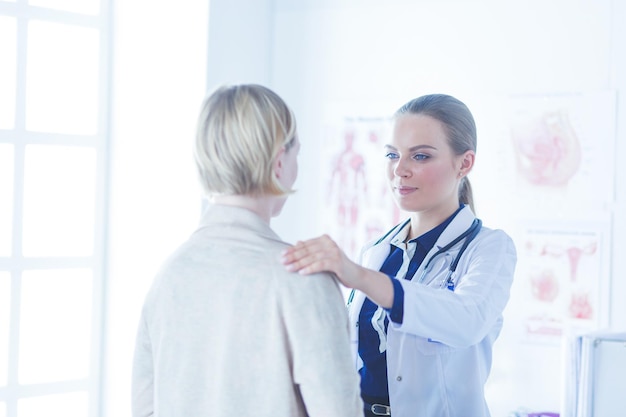 Doctor and patient discussing something while sitting at the table  medicine and health care concept