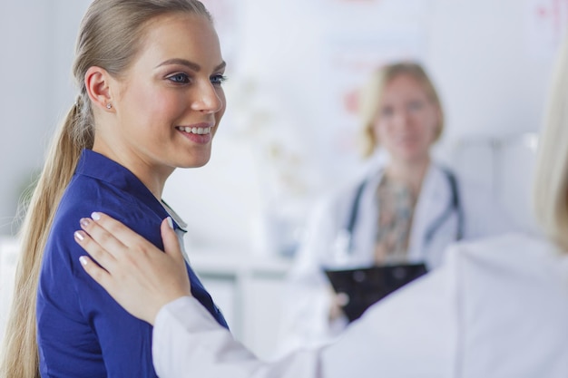 Doctor and patient discussing something while sitting at the table Medicine and health care concept