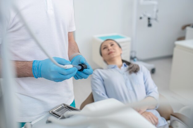 Doctor and a patient. Doctor and a female patient at the dentists office before teeth restoration