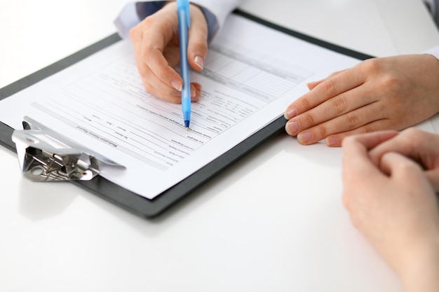 Doctor and patient sitting at the desk. Medicine and health care concept