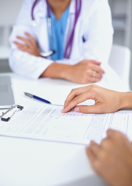 Doctor and patient sitting on the desk  at office, isolated