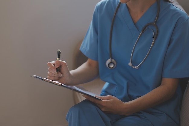 Doctor and patient talking while sitting at the desk in hospital office closeup of human hands Medicine and health care concept