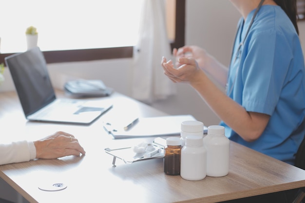 Doctor and patient talking while sitting at the desk in hospital office closeup of human hands Medicine and health care concept