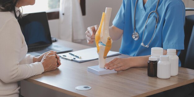 Doctor and patient talking while sitting at the desk in hospital office closeup of human hands Medicine and health care concept