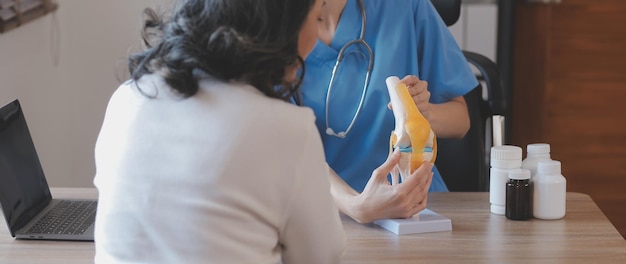 Doctor and patient talking while sitting at the desk in hospital office closeup of human hands Medicine and health care concept