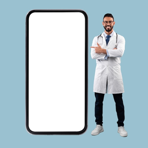 Doctor pointing at big white empty smartphone screen mockup